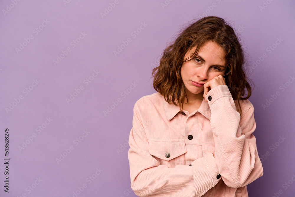 Young caucasian woman isolated on purple background who feels sad and pensive, looking at copy space. Young caucasian woman isolated on purple background who feels sad and pensive, looking at copy space.