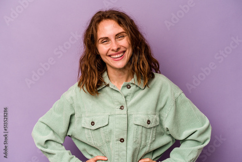 Young caucasian woman isolated on purple background happy, smiling and cheerful. © Asier