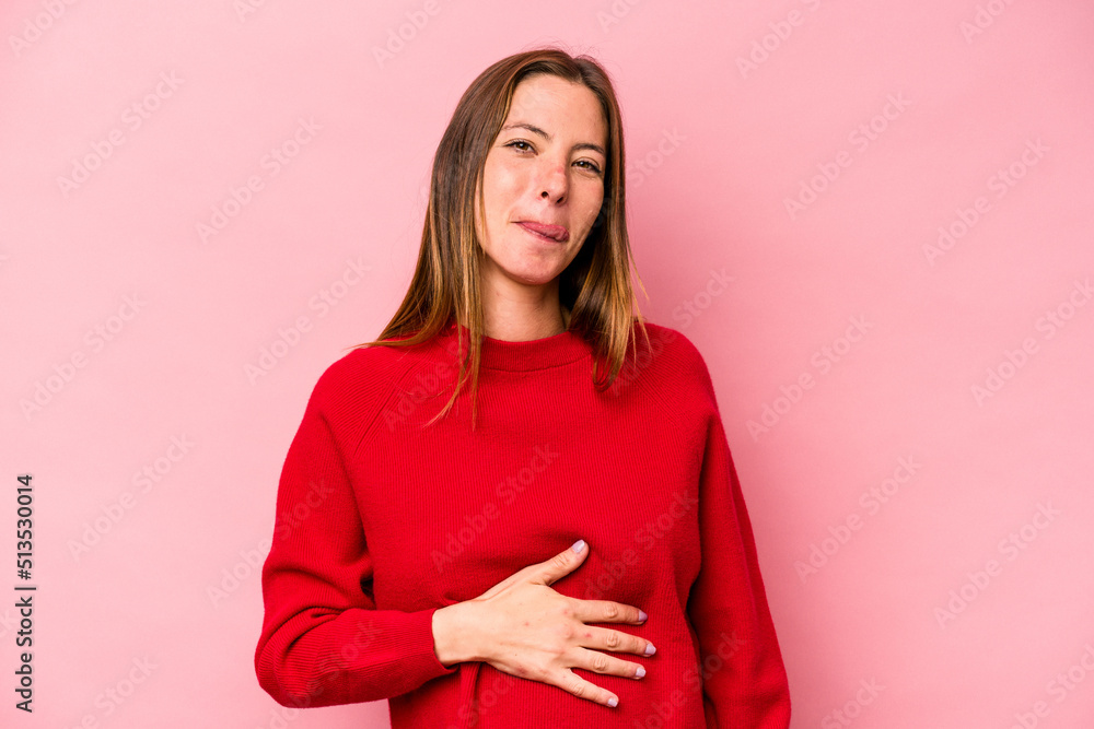 Young caucasian pregnant woman isolated on white background touches tummy, smiles gently, eating and satisfaction concept. Young caucasian pregnant woman isolated on white background touches tummy, smiles gently, eating and satisfaction concept.