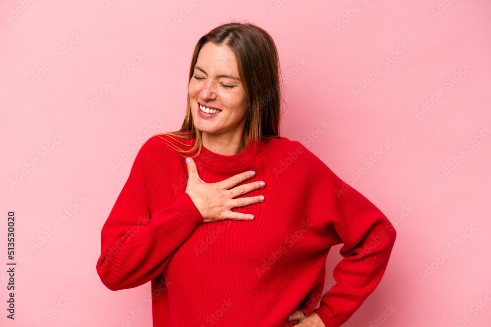 Young caucasian pregnant woman isolated on white background laughing keeping hands on heart, concept of happiness. Young caucasian pregnant woman isolated on white background laughing keeping hands on heart, concept of happiness.