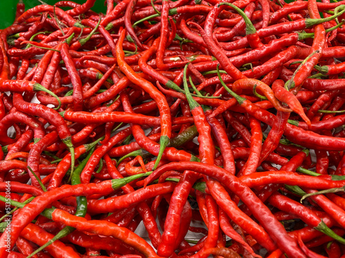 pile of fresh red chili peppers in the market. cabai merah or cabe merah, one of very popular ingredients in Indonesia.