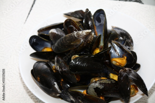 closeup of mussels on a white plate