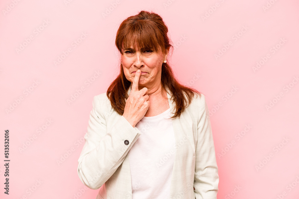 Middle age caucasian woman isolated on pink background thinking and looking up, being reflective, contemplating, having a fantasy.