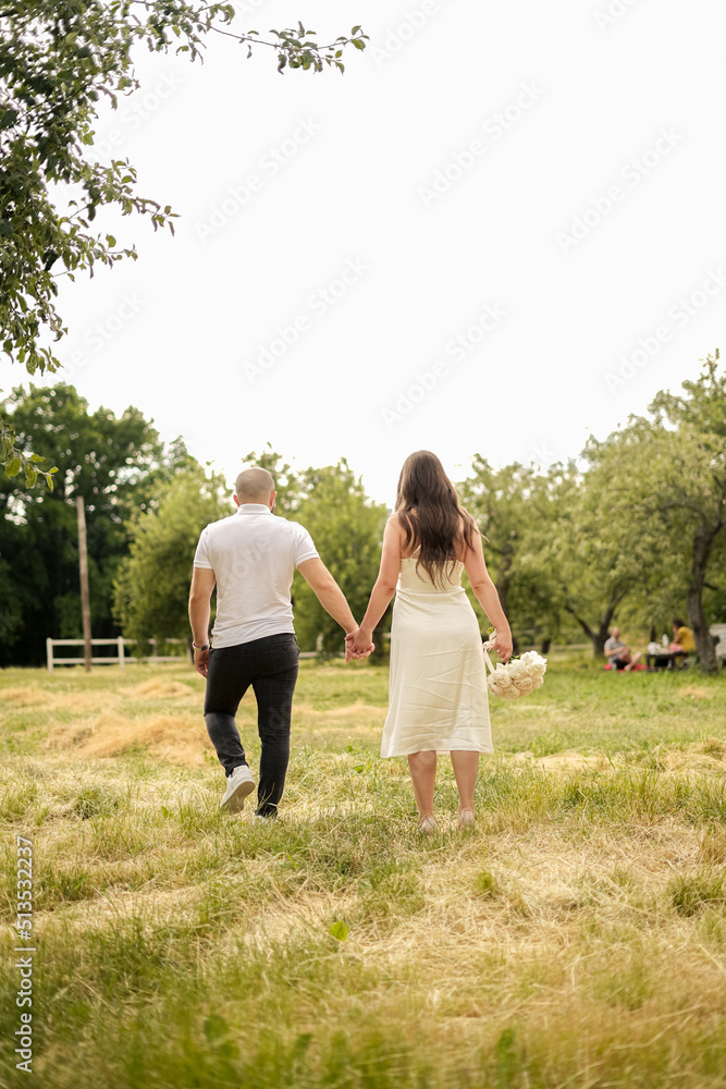 bride and groom walking through the woods at a wedding photo shoot