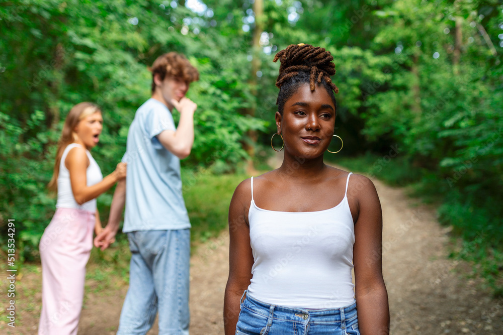 Disloyal man walking with his girlfriend and looking amazed at another seductive girl Disloyal man walking with his girlfriend and looking amazed at another seductive girl