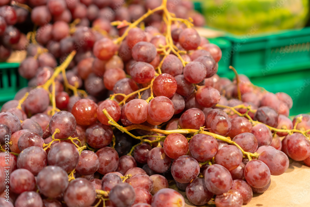 Round light purple grapes on the counter in the store close-up Round light purple grapes on the counter in the store close-up