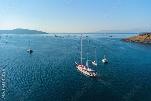 Aerial view of a white yacht crossing Bodrum Harbor, Turkey © efired