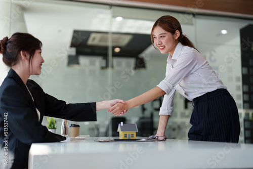 Portrait of a real estate agent shaking hands with customers to congratulate them on signing contracts to purchase house. agreement, insurance and deals concept.