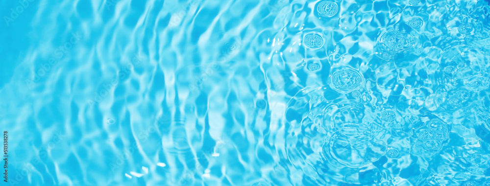 Pure clear water background. Ripples of aqua. Bubbles reflect light on the water surface. Blue banner backdrop. Fresh clean and moisturized.