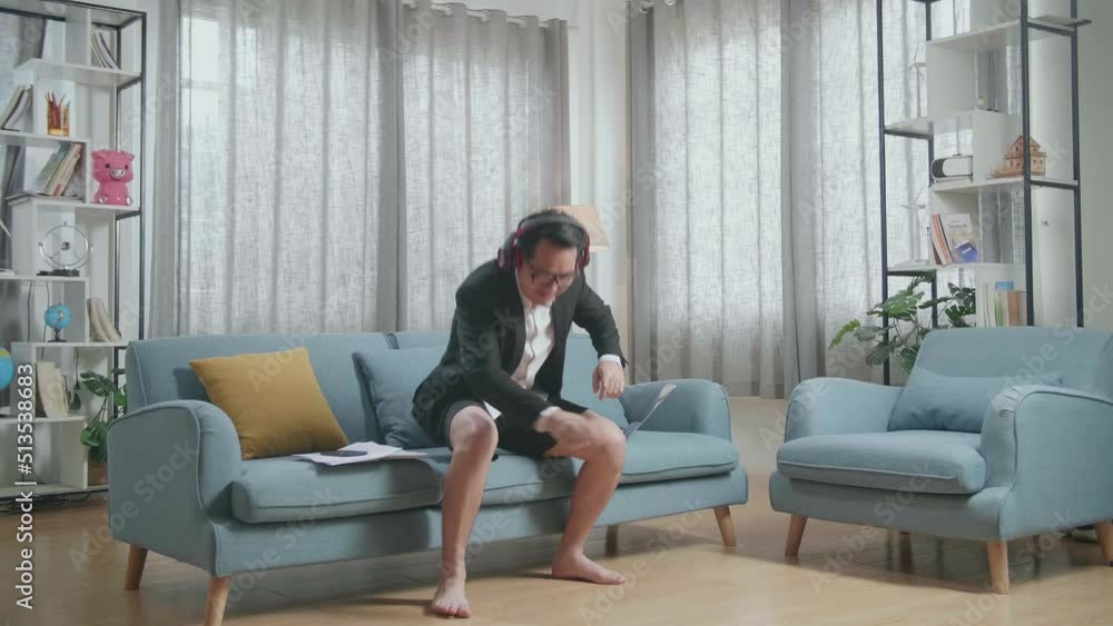 Full View Of Asian Businessman In Jacket And Shorts Listening To Music With Headphones And Dancing After Working With A Laptop At Home
Full View Of Asian Businessman In Jacket And Shorts Listening To Music With Headphones And Dancing After Working With A Laptop At Home