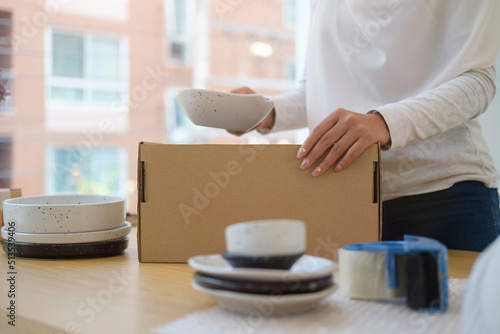 Cropped view of small business entrepreneur preparing parcel box of product for shipping to customer. Startup small business, Online selling, E-commerce.