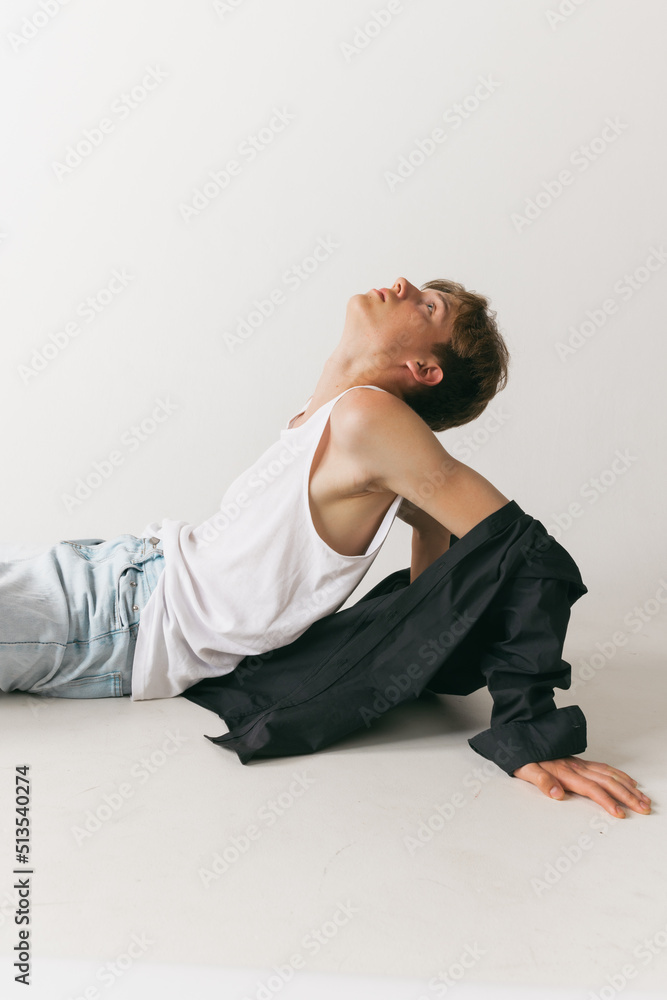 Portrait of young man, teen, student posing isolated over white studio background. Concept of fashion, youth, emotions, facial expression, ad Portrait of young man, teen, student posing isolated over white studio background. Concept of fashion, youth, emotions, facial expression, ad