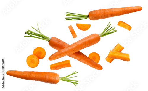 Foto Carrots and pieces fly close-up on a white background. Isolated