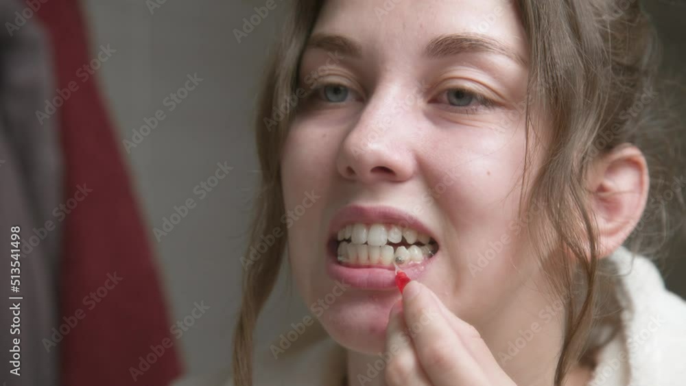 Caucasian Woman uses an interdental brush to clean the interdental spaces. Professional oral care. Correction of bite of teeth Caucasian Woman uses an interdental brush to clean the interdental spaces. Professional oral care. Correction of bite of teeth