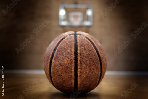 Basketball on Court with Hoops Rim Hardwood Floor Lights © Lane Erickson