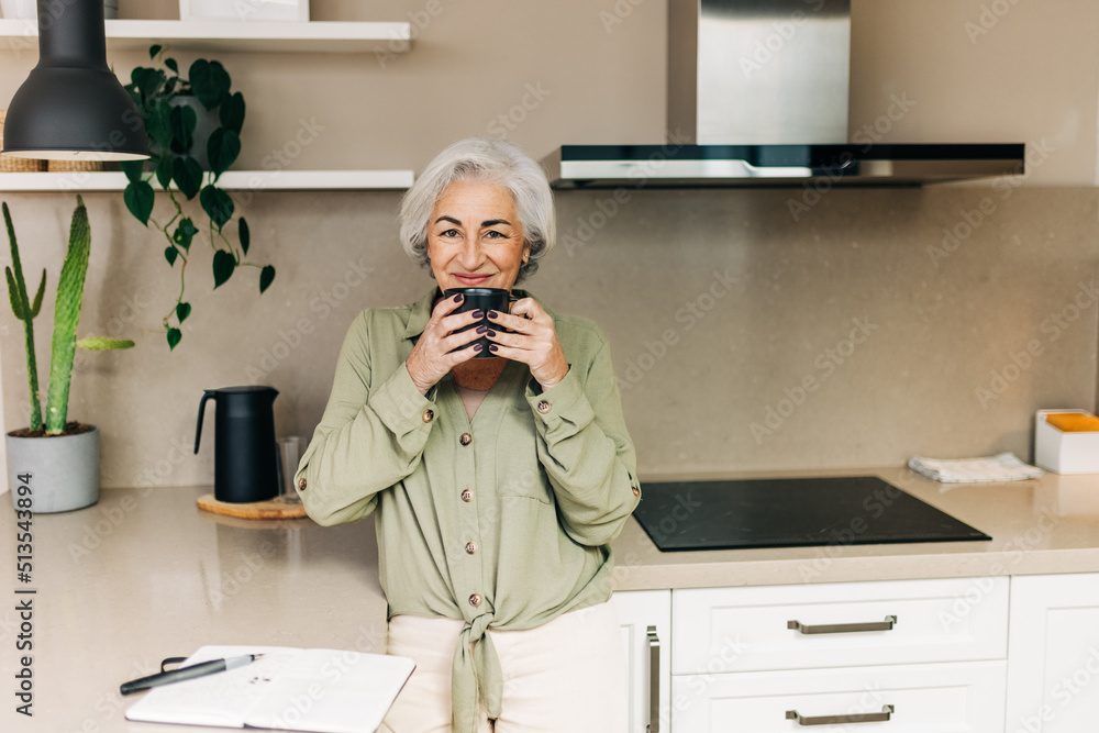 Elderly woman enjoying a cup of coffee at home Elderly woman enjoying a cup of coffee at home