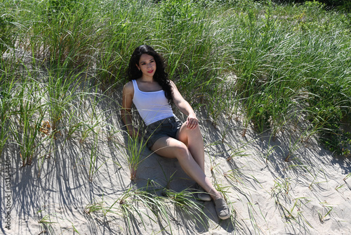 Beautiful young woman outdoors, in a park, at the beach