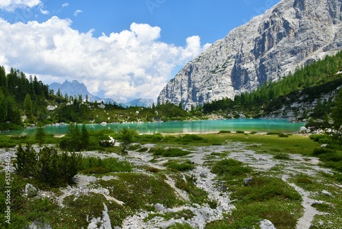 Alpine lake Sorapis in Dolomite Alps near Cortina d'Ampezzo in Veneto region and Belluno province in Italy with white clouds covering the mountain peaks behind photo