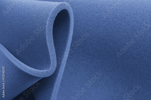 Foam sponge rolled up.
blue foam folding sponge. rubber texture sheet with wavy edges photo
