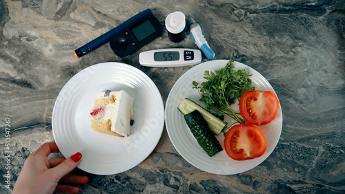 Diabetic devices - glucometer, lancet and insulin. Piece of cake and fresh vegetables. Dilemma of choosing between healthy food and delicious sweets. High sugar. Adherence to diet and healthy eating