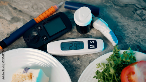 Diabetic devices - glucometer, lancet and insulin. Piece of cake and fresh vegetables. Dilemma of choosing between healthy food and delicious sweets. High sugar. Adherence to diet and healthy eating