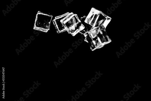 Fototapeta Naklejka Na Ścianę i Meble -  Ice cubes on a black background. ice falling on a black background for use as an illustration in a project
