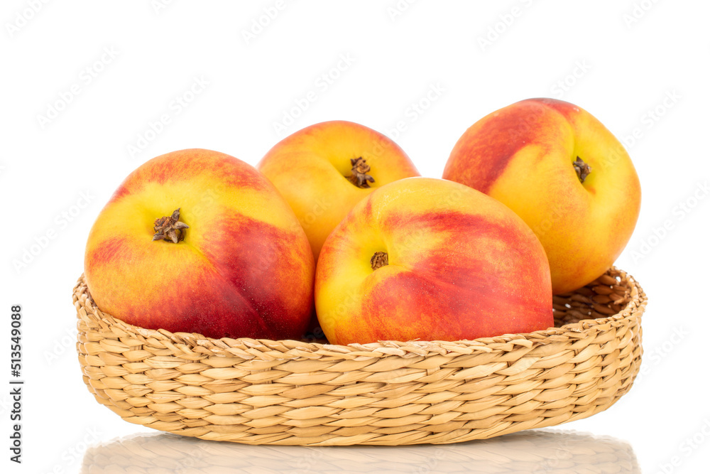 Several juicy organic nectarines with a straw basket, close-up, isolated on a white background. Several juicy organic nectarines with a straw basket, close-up, isolated on a white background.