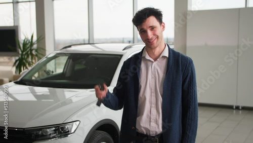 Wallpaper Mural portrait of joyful man with keys to a new car in his hands, smiling and looking at camera pointing his finger up Torontodigital.ca