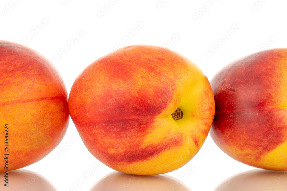 Three juicy organic nectarines, close-up, isolated on white background. Three juicy organic nectarines, close-up, isolated on white background.