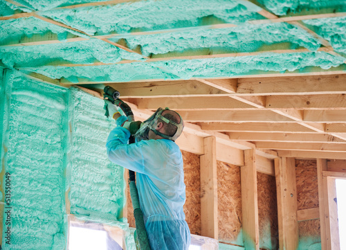 Obraz na plátně Male builder insulating wooden frame house
