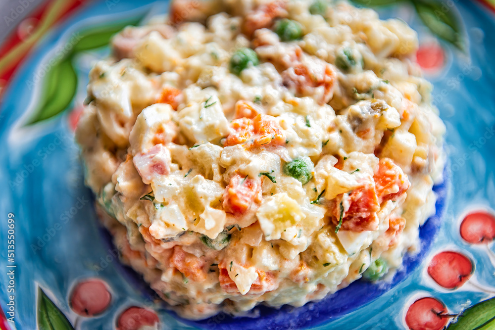 Traditional Ukrainian or Russian salad called olivie olivier macro closeup texture with boiled chopped potatoes, carrots, peas and onions in mayonnaise serving on plate Traditional Ukrainian or Russian salad called olivie olivier macro closeup texture with boiled chopped potatoes, carrots, peas and onions in mayonnaise serving on plate
