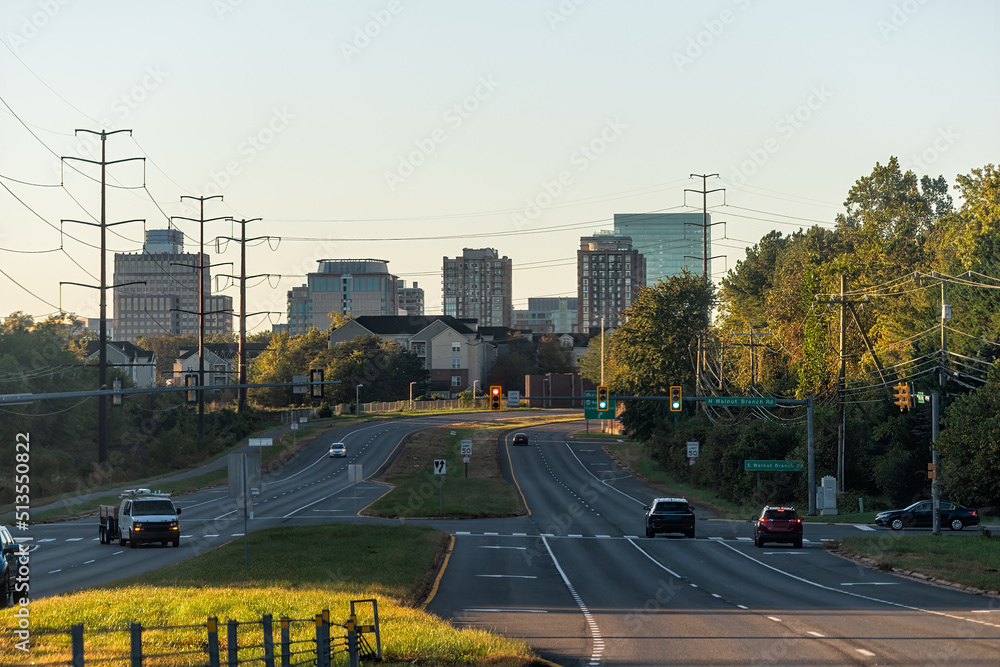Reston, USA - October 18, 2021: Reston, northern Virginia town center office building architecture in sunrise morning view of cityscape skyline and street road with traffic light and cars