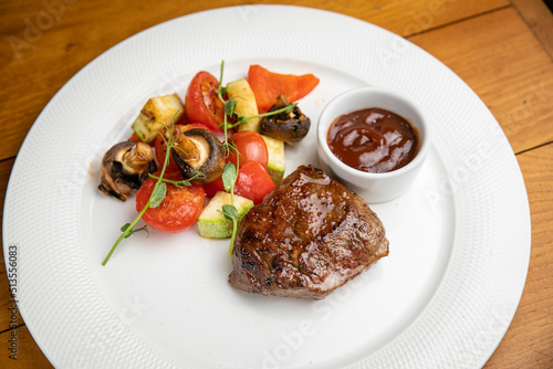 Steak with garnish and sauce on a plate 