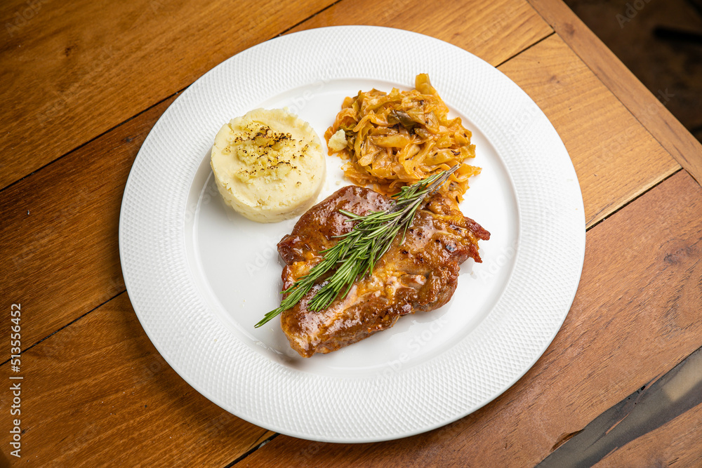 Steak with garnish and sauce on a plate
Steak with garnish and sauce on a plate