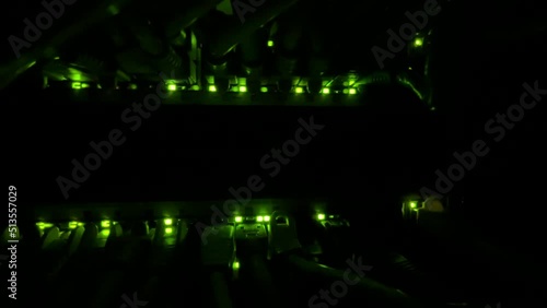 small LED lights from a network switch actively glow in the dark photo