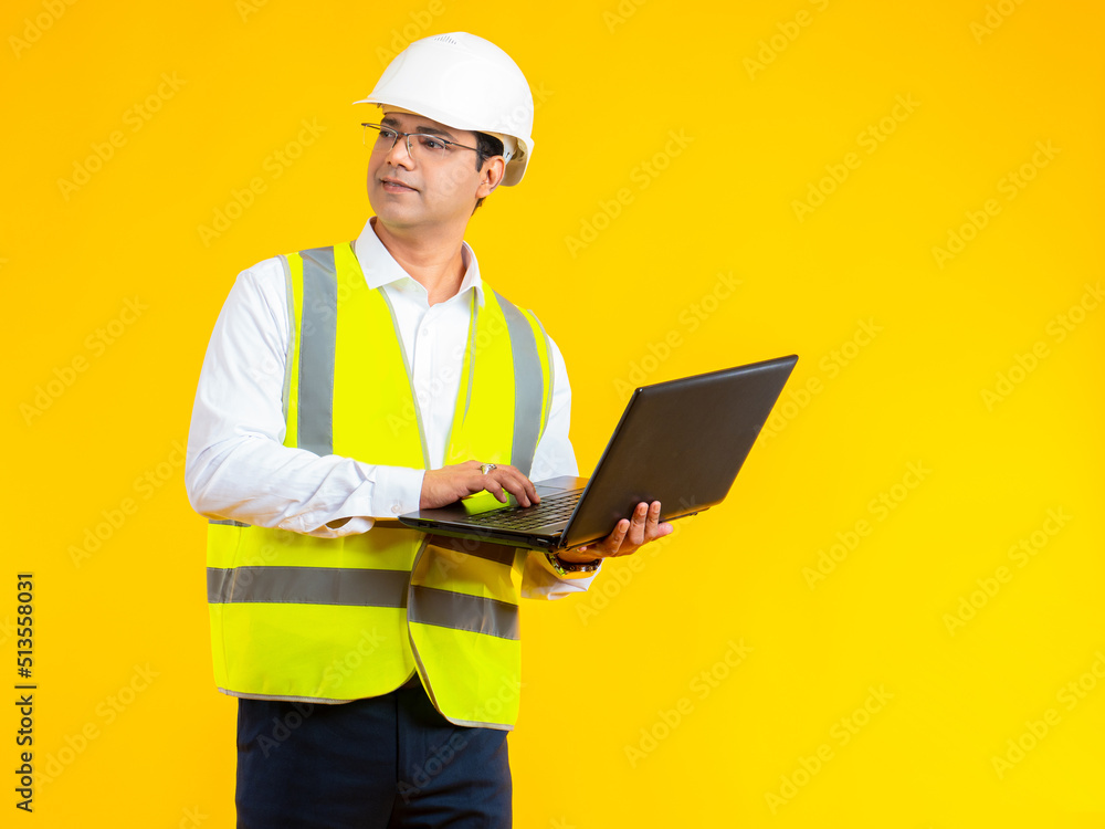 Builder on site. A man in a helmet is in a house under construction. The foreman orders by phone delivery of construction materials to the object.