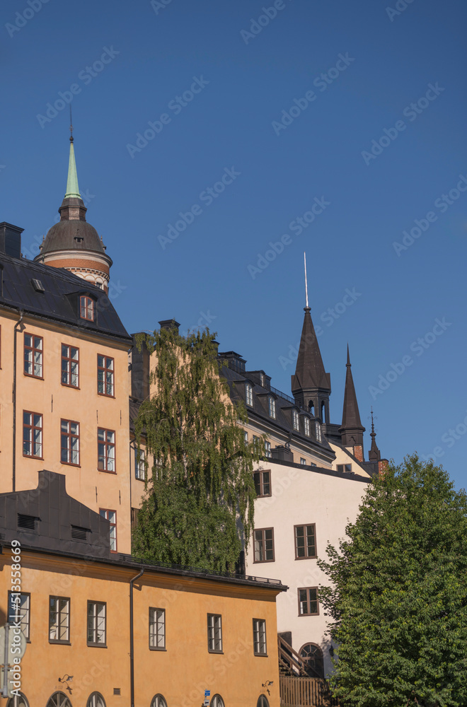 Facades, roofs and towers of old 1700s houses at the block Bastugatan in the district Södermalm a sunny summer day in Stockholm
