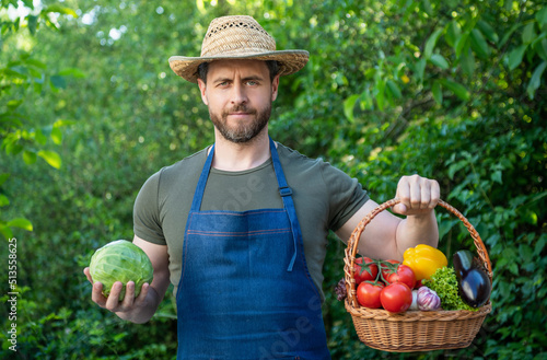 farm worker in straw hat hold basket full of vegetables