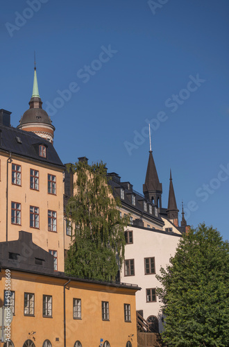Facades, roofs and towers of old 1700s houses at the block Bastugatan in the district Södermalm a sunny summer day in Stockholm