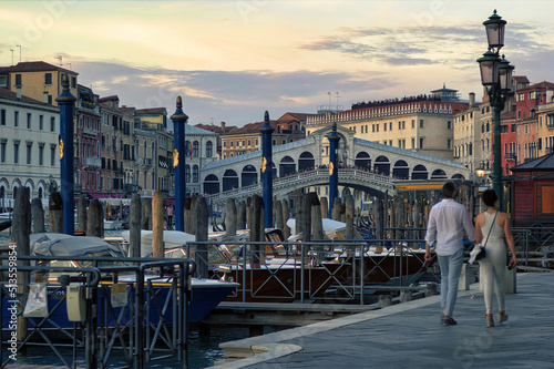 Venice, Italy: A couple walking holding hands against rialto bridge, a famous place known as one of the romantic destination