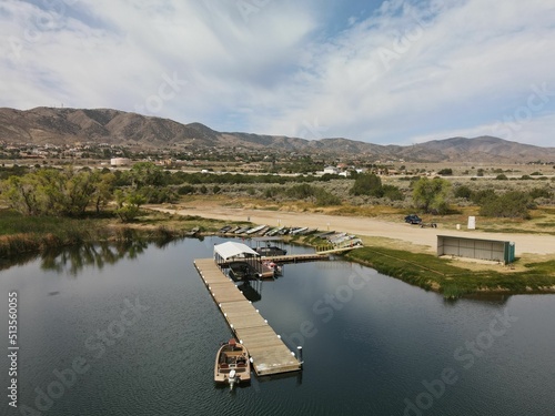 Wooden dock on the Lake Palmdale surrounded by mountains against a cloudy sky photo