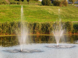 Two fountains in the lake at park.