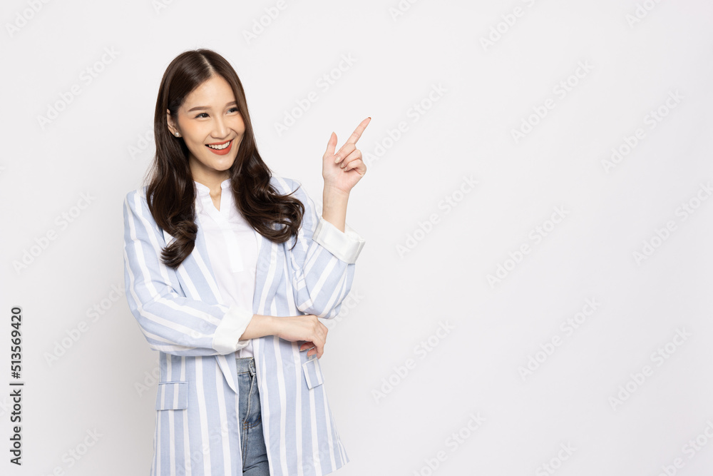 Young beautiful Asian businesswoman smiling and pointing to empty copy space isolated on white background Young beautiful Asian businesswoman smiling and pointing to empty copy space isolated on white background