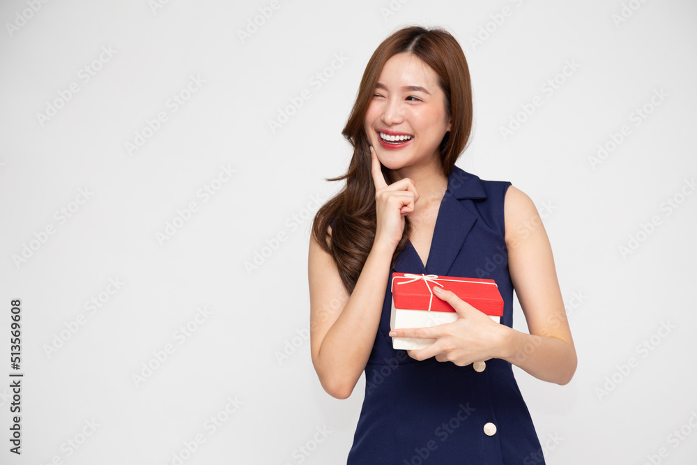 Happy Asian woman holding red gift box isolated on white background, Valentine day or Happy birthday concept Happy Asian woman holding red gift box isolated on white background, Valentine day or Happy birthday concept