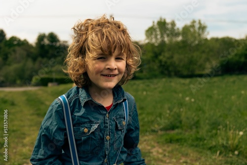 Obraz na plátne Closeup shot of an autistic Caucasian baby boy with blonde hair playing in a par