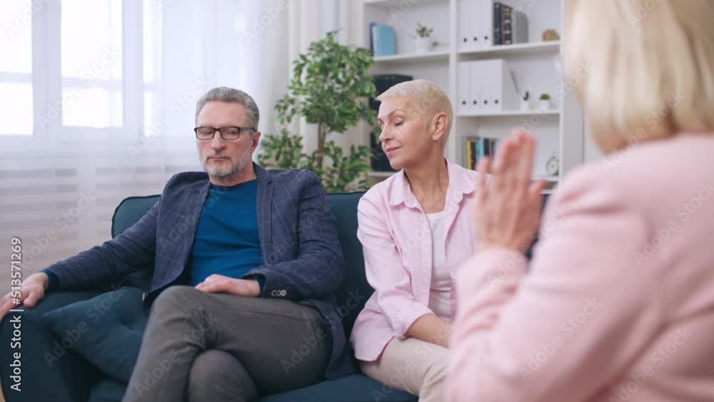 Couple in their 50s reconciling while talking with psychologist, saved marriage Couple in their 50s reconciling while talking with psychologist, saved marriage