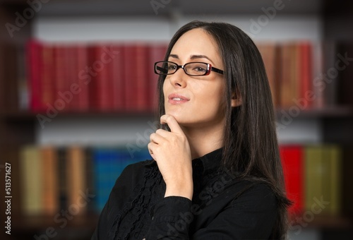 Serious young business woman looking away with pensive face, dreaming, thinking over project tasks, problem solving