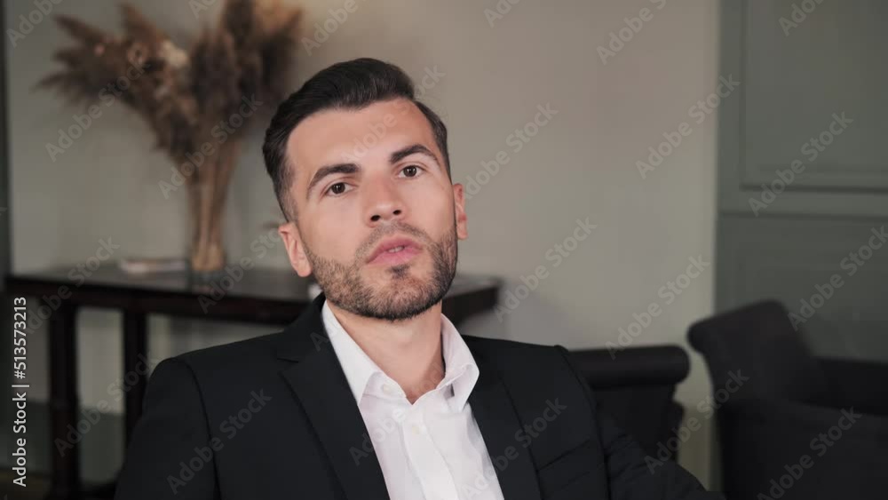 Serious bearded millennial stylish businessman looking at camera. Portrait of confident handsome smart young adult entrepreneur, leader, manager posing in lobby hotel. Closeup face business portrait. Serious bearded millennial stylish businessman looking at camera. Portrait of confident handsome smart young adult entrepreneur, leader, manager posing in lobby hotel. Closeup face business portrait.