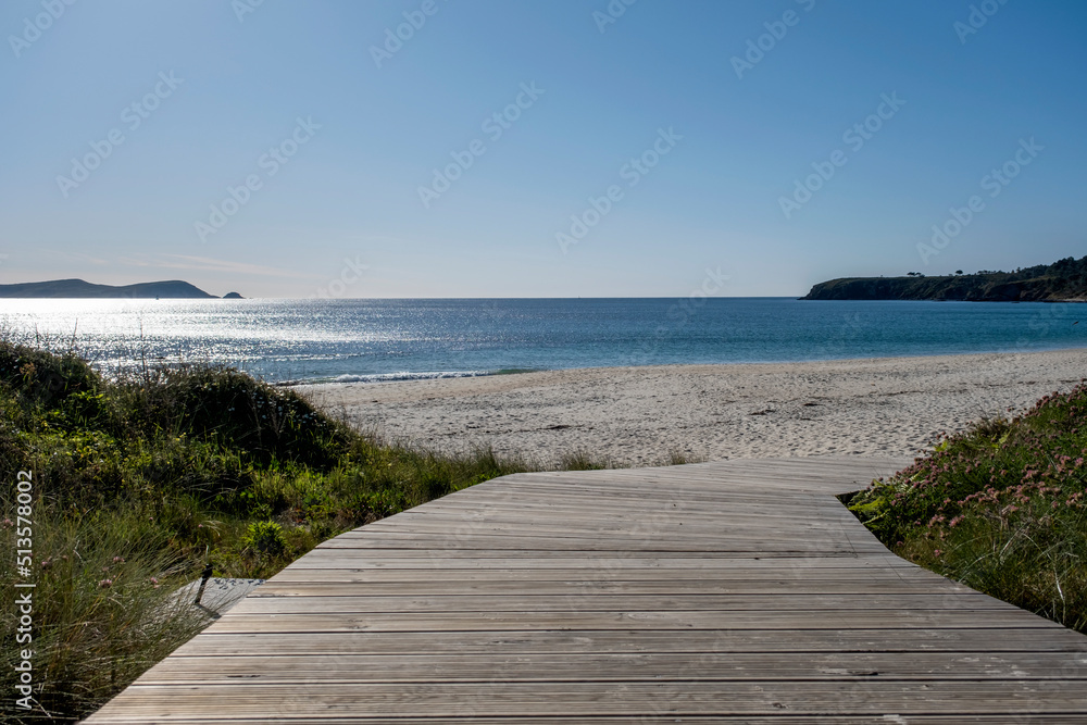 Wooden walkway leading to a sandy beach