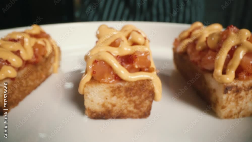 red fish on a sandwich is poured with creamy sauce red fish on a sandwich is poured with creamy sauce